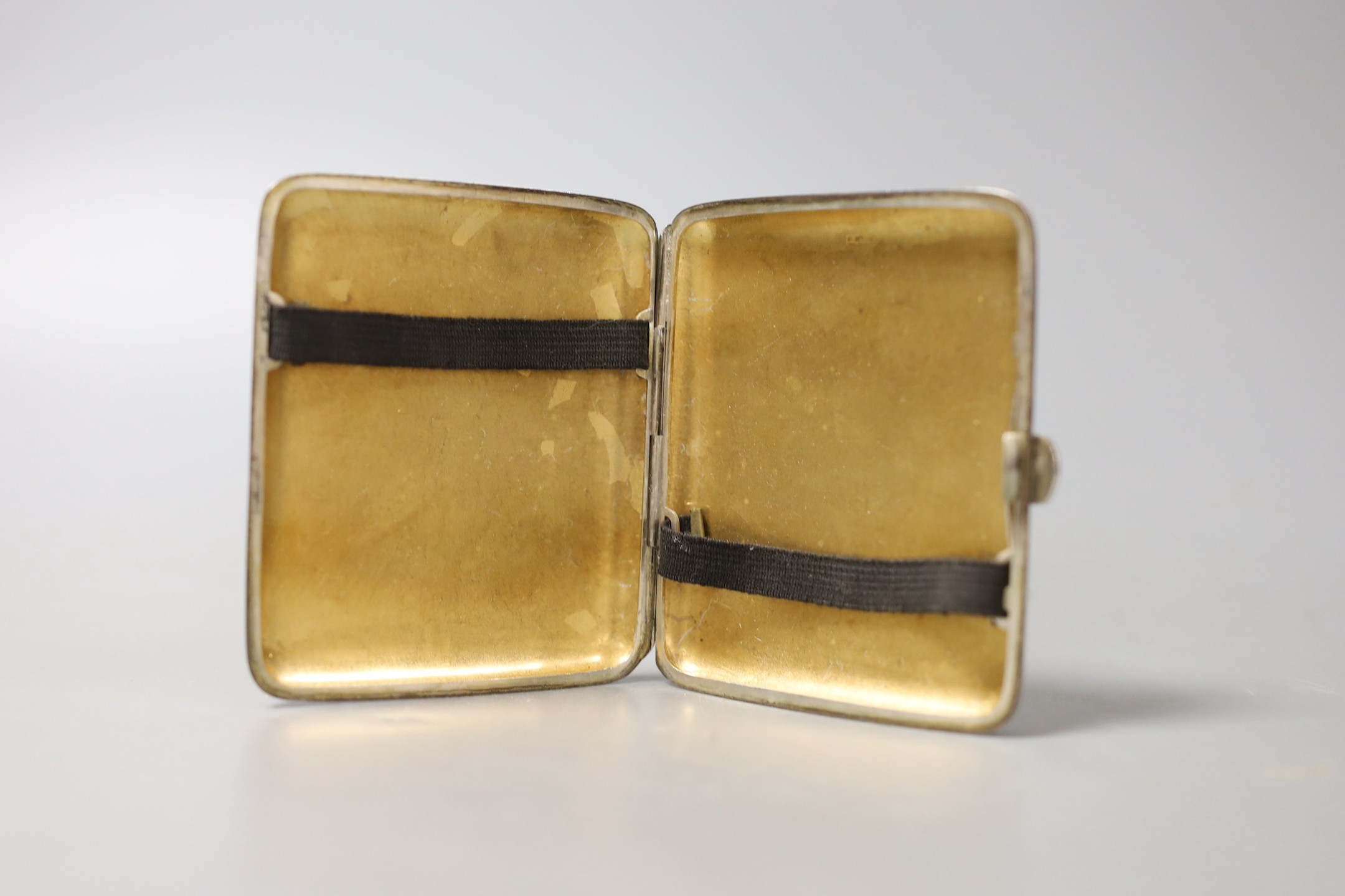 A white metal cigarette case and small silver including a pair of salts, condiment and napkin ring.